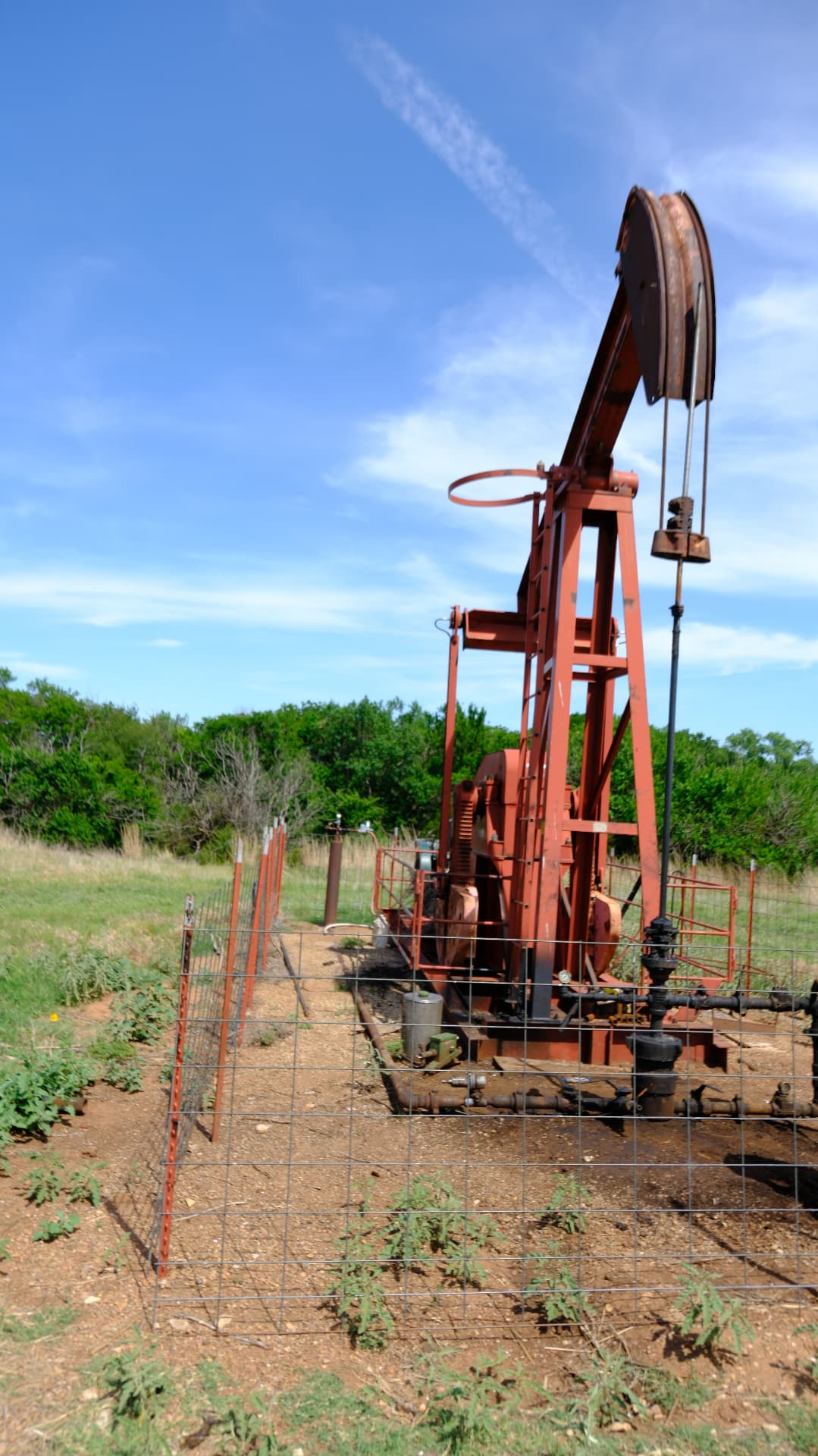 Red pumping unit operating at a remote lease